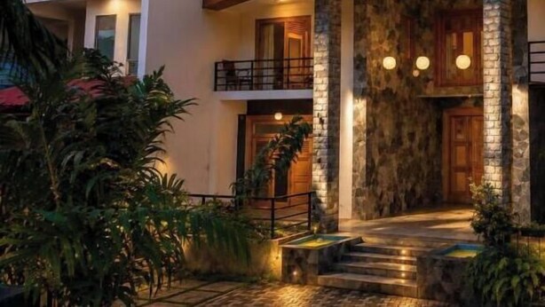 A multi-story building with a stone facade, balconies, and a well-lit entrance. - 3 Arch Resort - Ella (Ella)