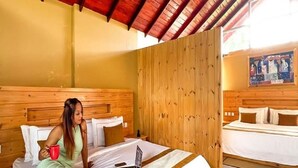 A room with a wooden headboard, a bed with white bedding, a laptop on the bed, and a red mug. - 3 Arch Resort - Ella (Ella)
