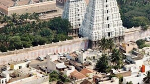 A temple complex with multiple gopurams, surrounded by residential buildings and greenery. - SS Paradise Residency (Tiruvannamalai)