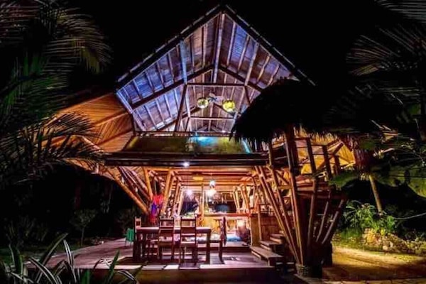 The bungalow lit up at night is a beautiful space!
