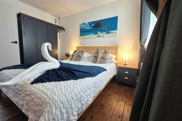 Ample wardrobe space and bedside table storage.