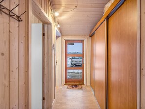 A narrow wooden hallway with a door leading to a garage. - "Gebko" - 750m from the sea by Interhome (Løkken)