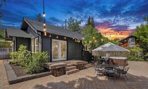 A house with a patio, outdoor seating, and a barbecue area. - Bluebird Day - Box Factory Bungalow, A charming 2-bedroom retreat. (Bend)
