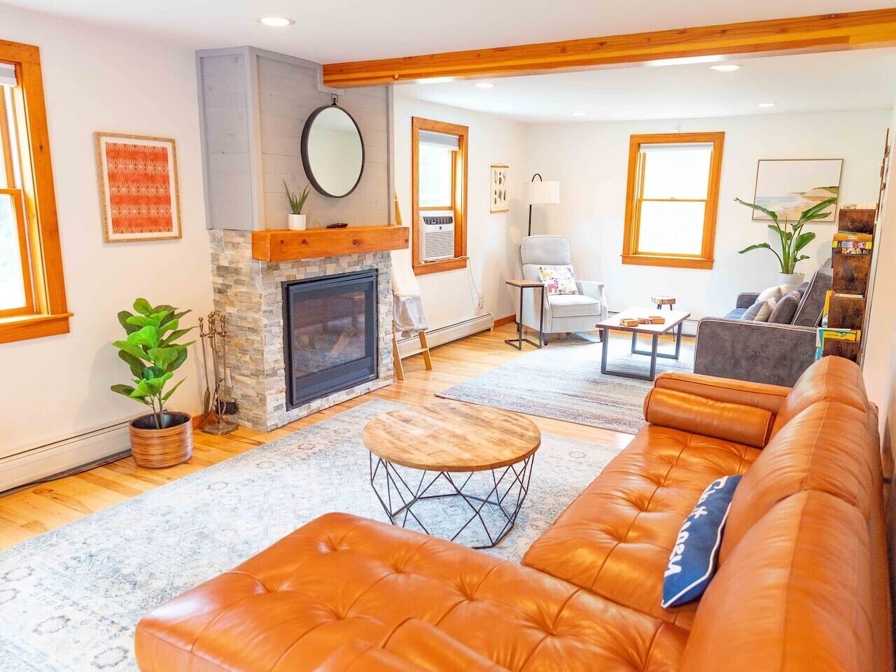Large living room with comfortable leather couch, sofa bed and recliner chair.