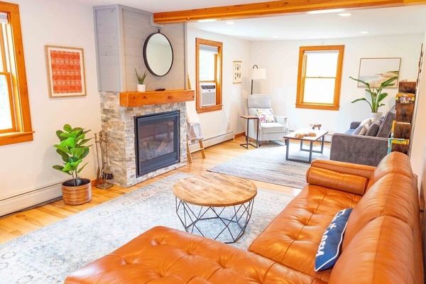 Large living room with comfortable leather couch, sofa bed and recliner chair.