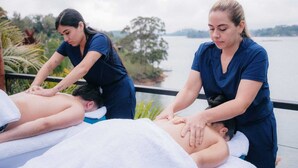A massage therapy session taking place by a lakeside. - Boreal Glamping (Guatape)
