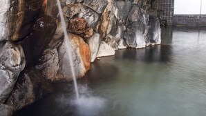 A hot spring with a waterfall, surrounded by rock formations. - Nuruyu Onsen Sato Ryokan (Kurihara)