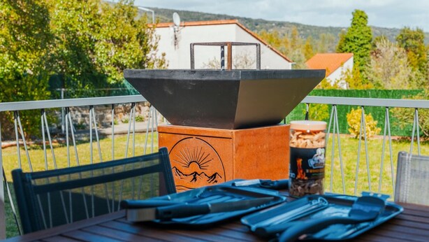 A patio with a grill, a table with cutlery, and a chair. - Casa Vama Pool Private Cinema (Amelie-les-Bains-Palalda)