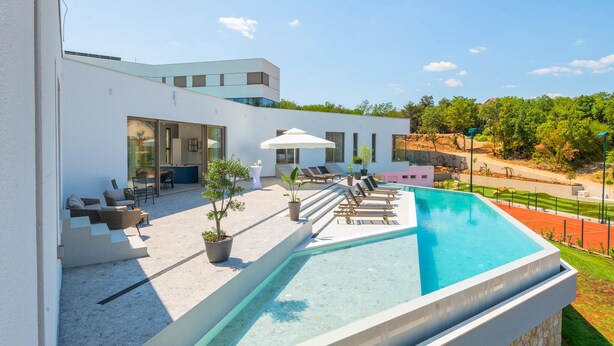 A modern house with a swimming pool, outdoor seating, and a view of the surrounding landscape. - Beautiful home in Zmijavci with sauna (Zmijavci)