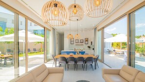 A modern interior with a dining area, sofas, and large windows. - Beautiful home in Zmijavci with sauna (Zmijavci)