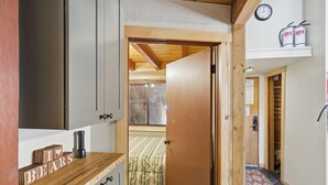 A kitchen with wooden cabinets, a coffee maker, and a 'I ♥ BEARS' sign.