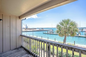 A balcony with a view of a marina, including boats and a crane. - Waterfront Condo with Marina Views in Panama City (Panama City)