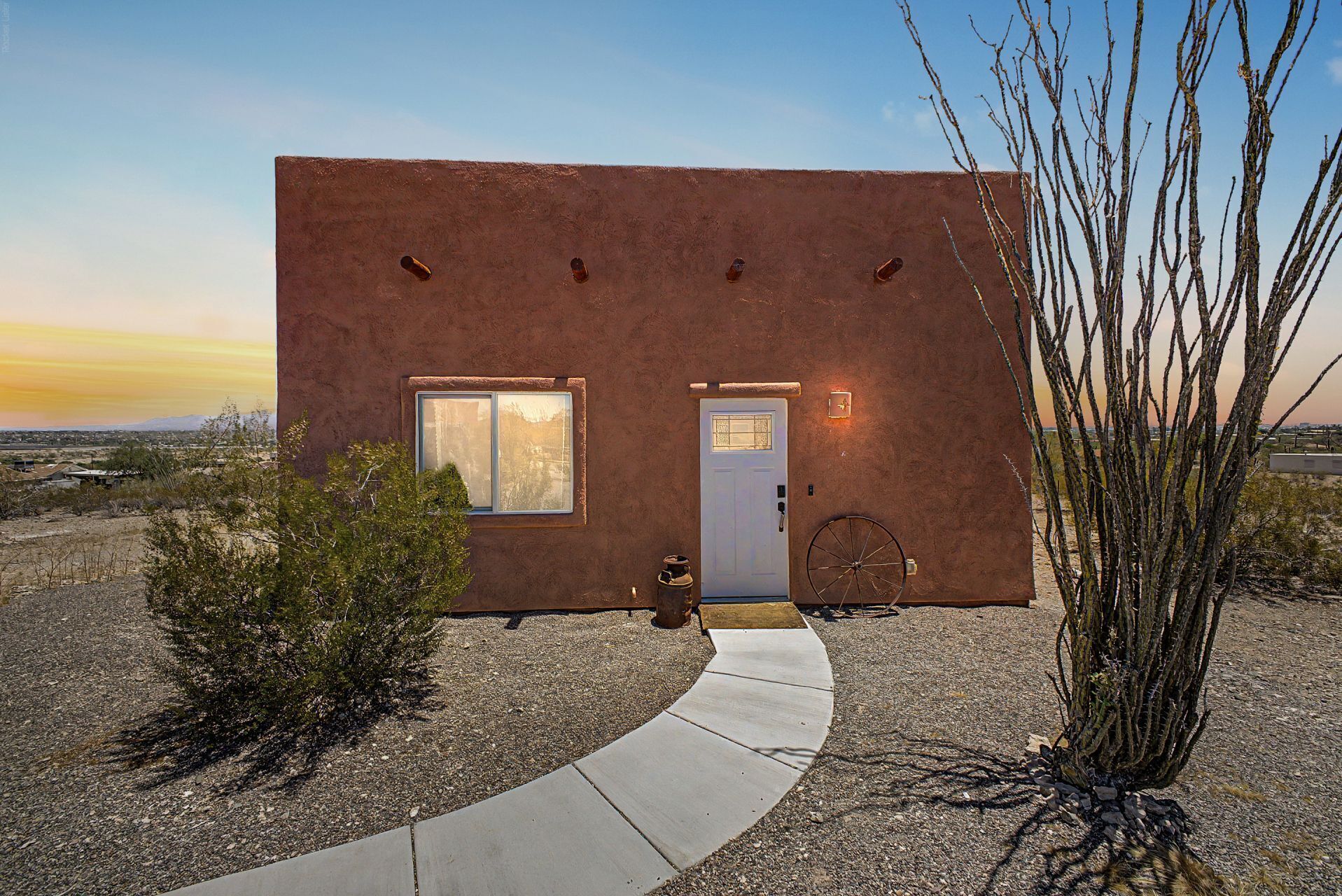 A modern house with a flat roof, a front door, and a window.