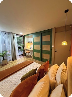 A modern living room with a sofa, a coffee table, and a view of the outside. - Casa Agaveria -Boutique Stay in Condesa ( 4 bedrooms + Balconies) (Ciudad de México)