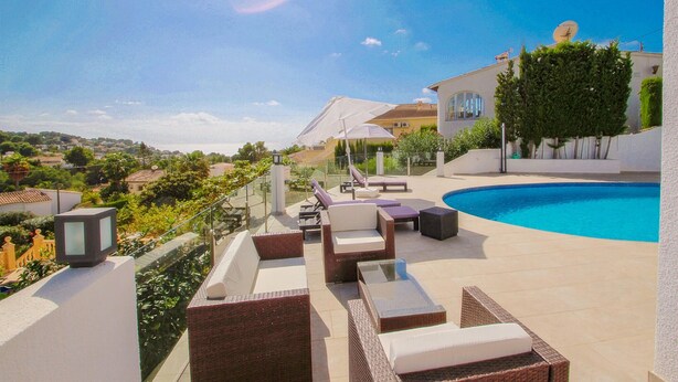 A poolside area with lounge chairs, a swimming pool, and a view of the surrounding landscape. - Stunning home in Benissa (Benissa)