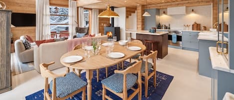 A modern interior with a dining area, kitchen, and living space.