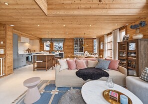 A cozy cabin interior with a living area, kitchen, and dining space. - Discover Chalet SkyLodge by Mrs Miggins, an elegant alpine retreat nestled in the heart of Grimentz, (Grimentz)