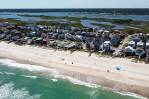 An aerial view of a coastal residential area with houses, a beach, and a body of water. - Ocean + ICW Views 7BR, Pool, Cabana, Elevator (Surf City)