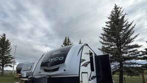 A recreational vehicle with a 'Jankyco' logo, a black and white color scheme, and a grill attached to the front. - Montana Moon on the Lake "White Hawk" RV #3 (Babb)