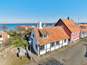 A coastal residential area with houses featuring red-tiled roofs and white walls. - "Ariela" - 150m from the sea by Interhome (Allinge)