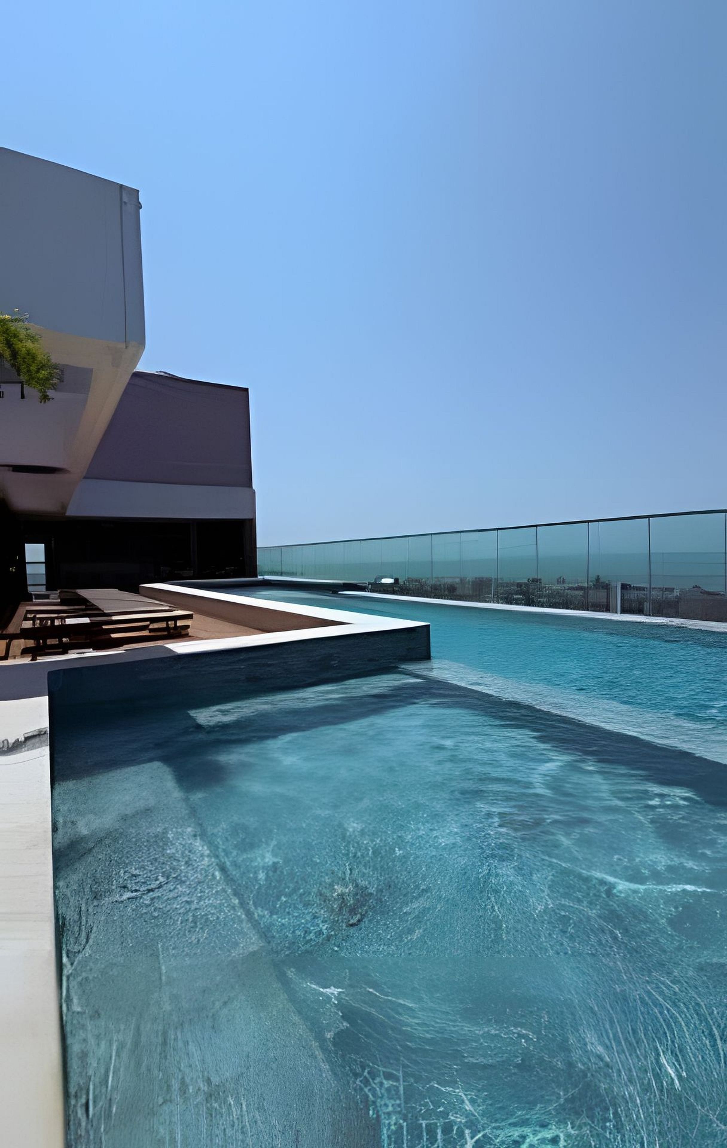 A swimming pool with a clear view of the city skyline in the background.