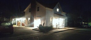 A two-story house with a garage and a covered front porch.