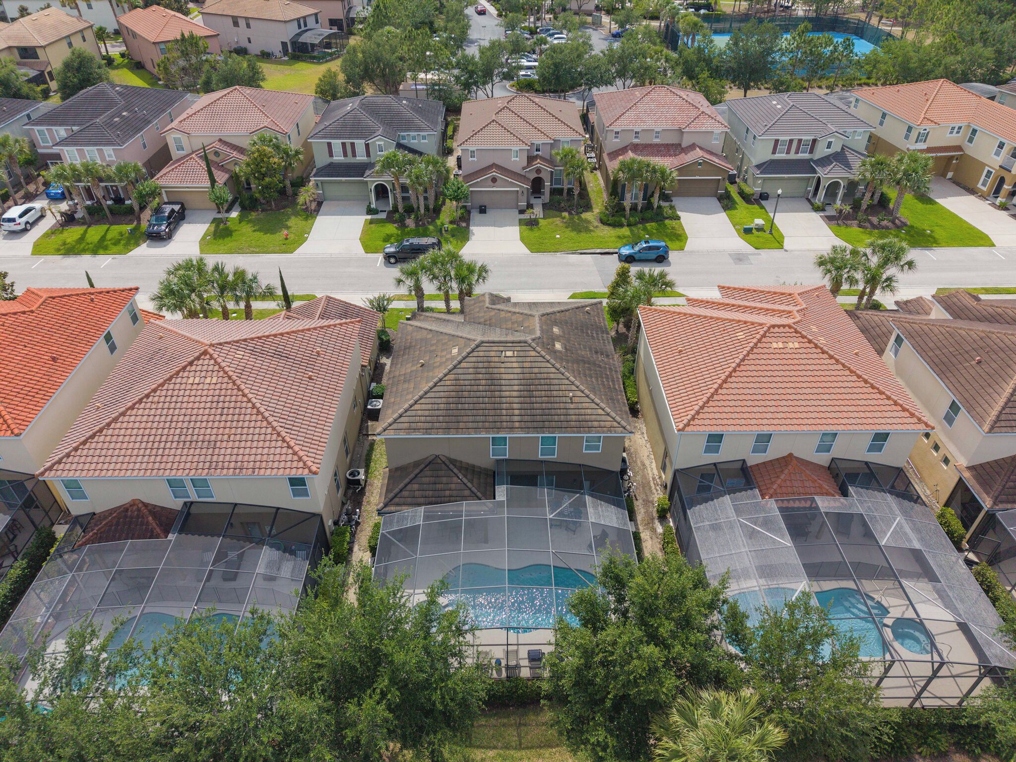 Un quartier résidentiel avec des maisons, une piscine et une route.