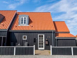 A building with a red-tiled roof, a door with a glass panel, and a small window. - "Verner" - 990m from the sea by Interhome (Skagen)
