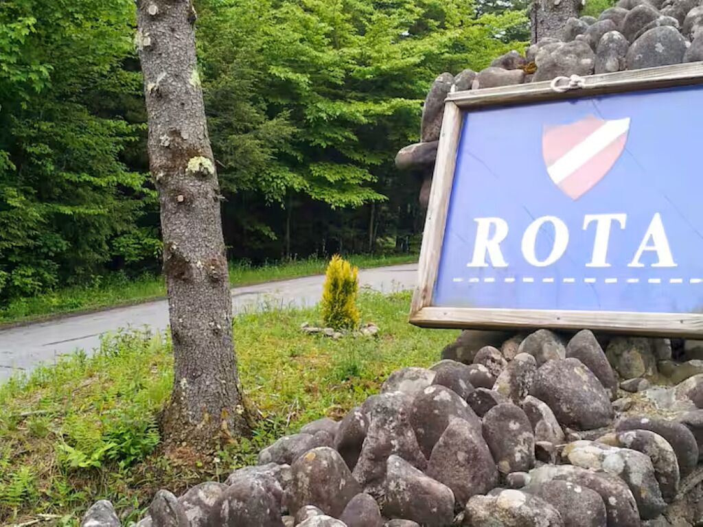 A sign with the word 'ROTA' and a shield emblem.