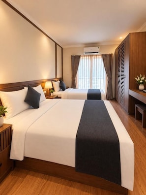 A hotel room with two beds, a desk, and a window with curtains. - Hanoi Serenity Hotel 2 (Hanoi)