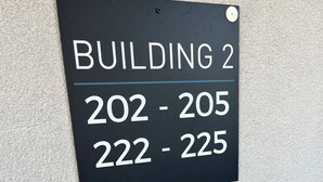 A sign indicating Building 2 with room numbers 202-205 and 222-225.