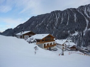 A snow-covered mountain resort with wooden buildings, a ski lift, and a clear sky. - Abanico Ferien, (Samnaun-Laret) by Interhome (Samnaun)