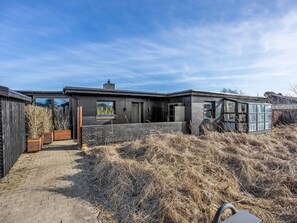 A modern house with a brick pathway leading to the entrance, a large window, and a small garden area. - "Falk" - 900m from the sea by Interhome (Bindslev)
