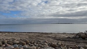 A beach with a rocky shoreline and a distant island. - "Algut" - 80m from the sea by Interhome (Haderslev)