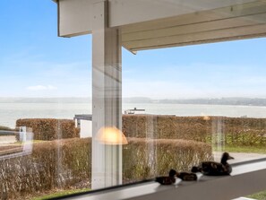 A view of a body of water with a bridge in the distance, a hedge, and a lamp post. - "Lien" - 100m from the sea by Interhome (Juelsminde)