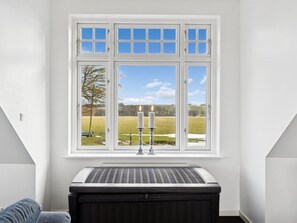 A room with a white window, a radiator, and a candle on the windowsill. - "Carola" - 1km from the sea by Interhome (Svaneke)
