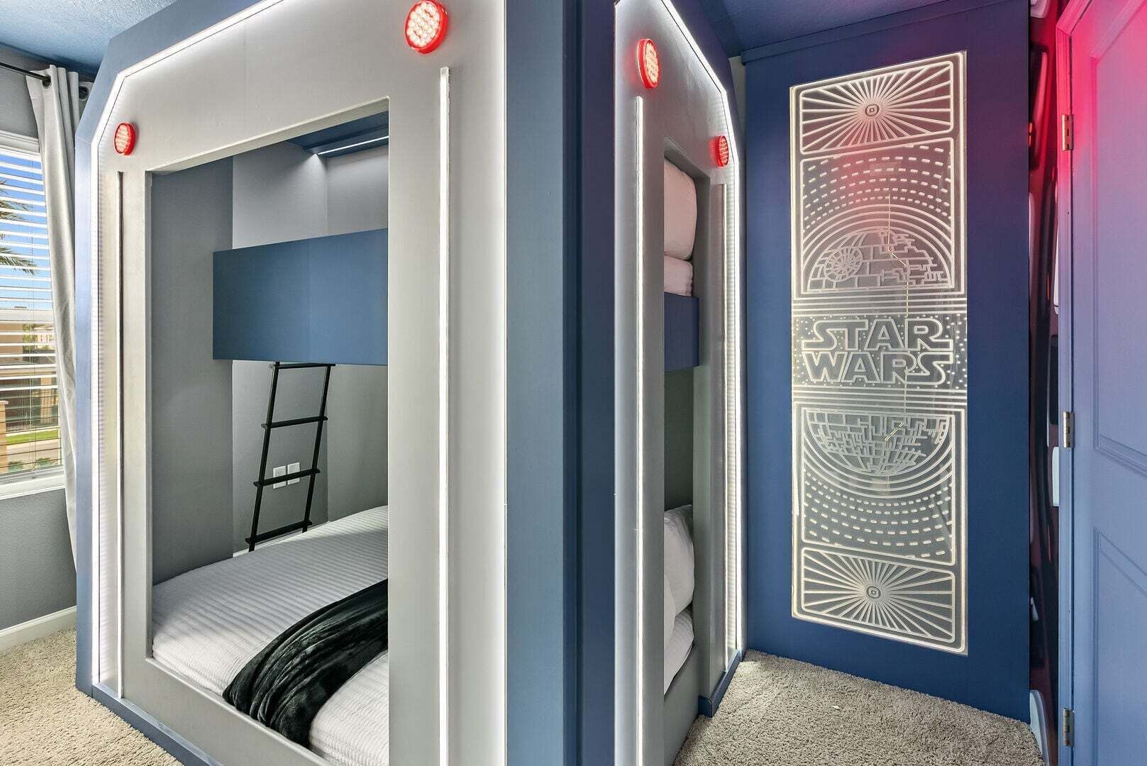 A Star Wars-themed room with bunk beds, a ladder, and a Star Wars mural.
