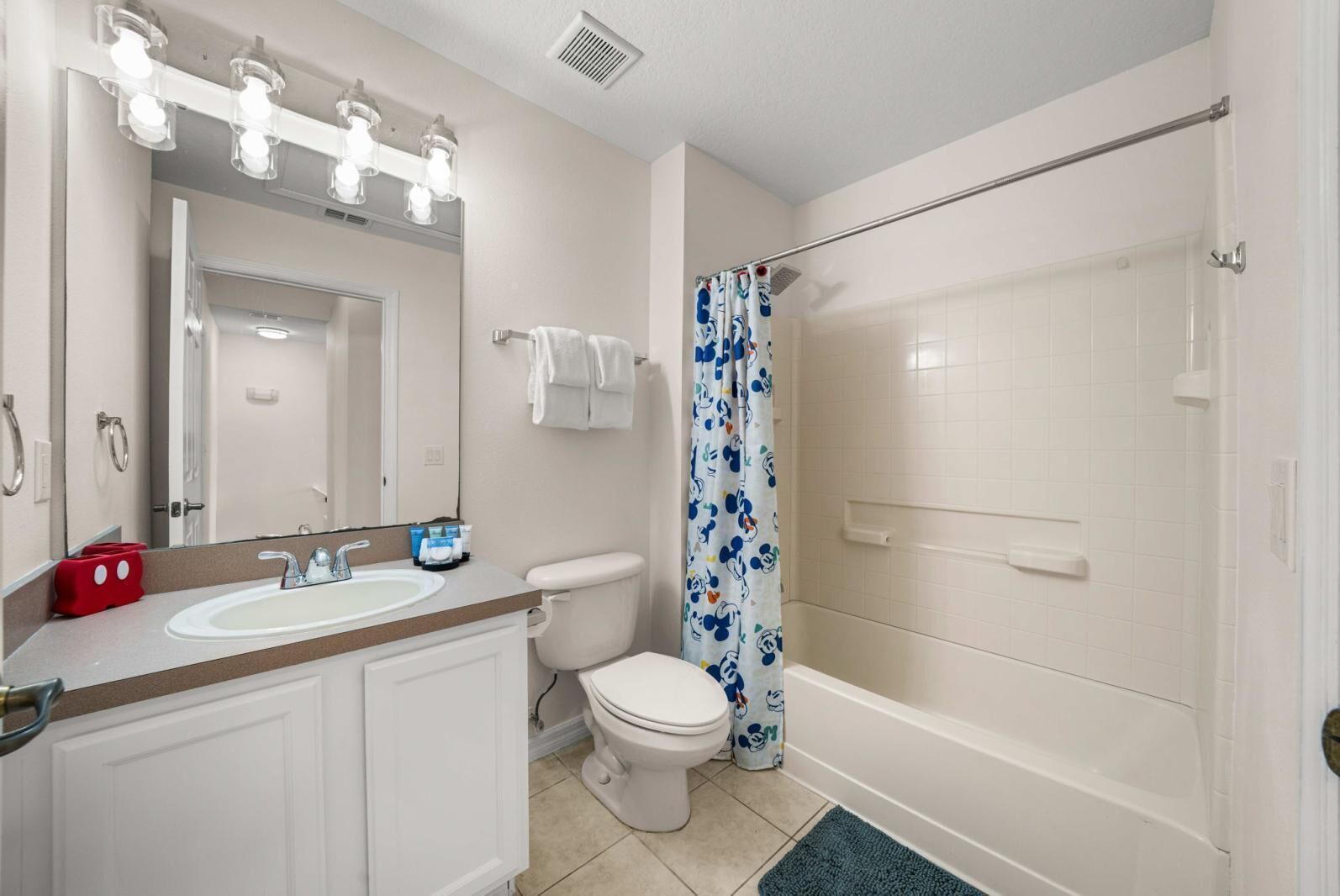 A bathroom with a sink, toilet, and shower.