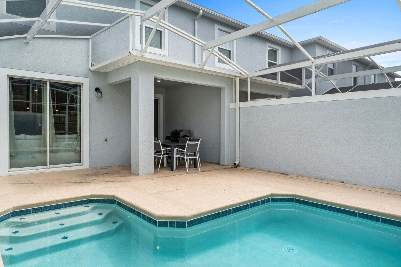Il s’agit d’une propriété résidentielle dotée d’une piscine, d’un patio couvert avec mobilier d’extérieur et d’un garage.