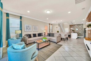 A modern living room with a sofa, armchairs, a coffee table, and a dining area. - Modern Home, Private Pool. Sleeps 15 Ww102 (Kissimmee)