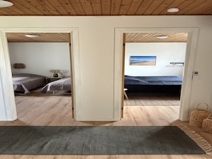 A room with a bed, a small table, and a wall-mounted lamp. - "Jorek" - 700m from the sea by Interhome (Lemvig)
