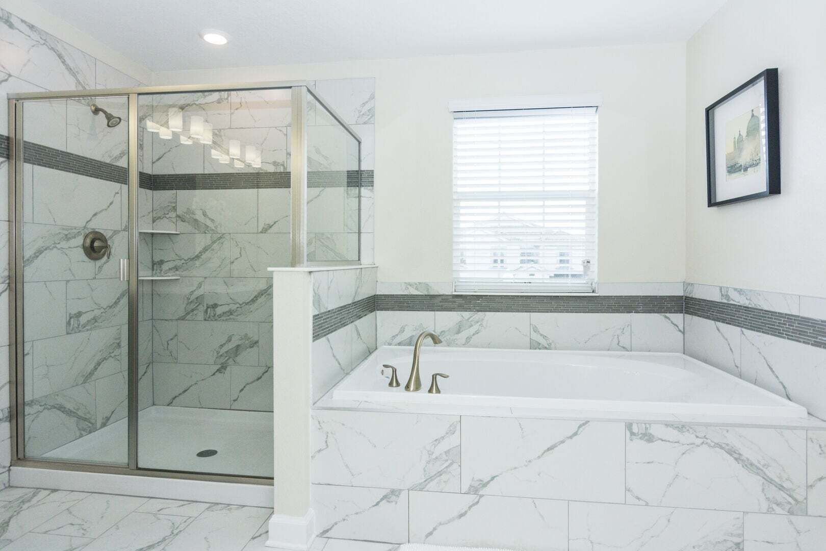 A bathroom with a glass-enclosed shower, a freestanding bathtub, and a window with blinds.