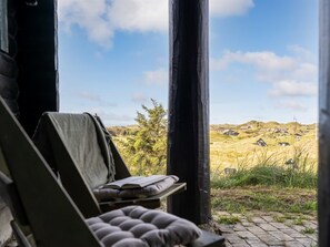 Ein Zimmer mit Blick auf eine grüne Landschaft und Häuser.