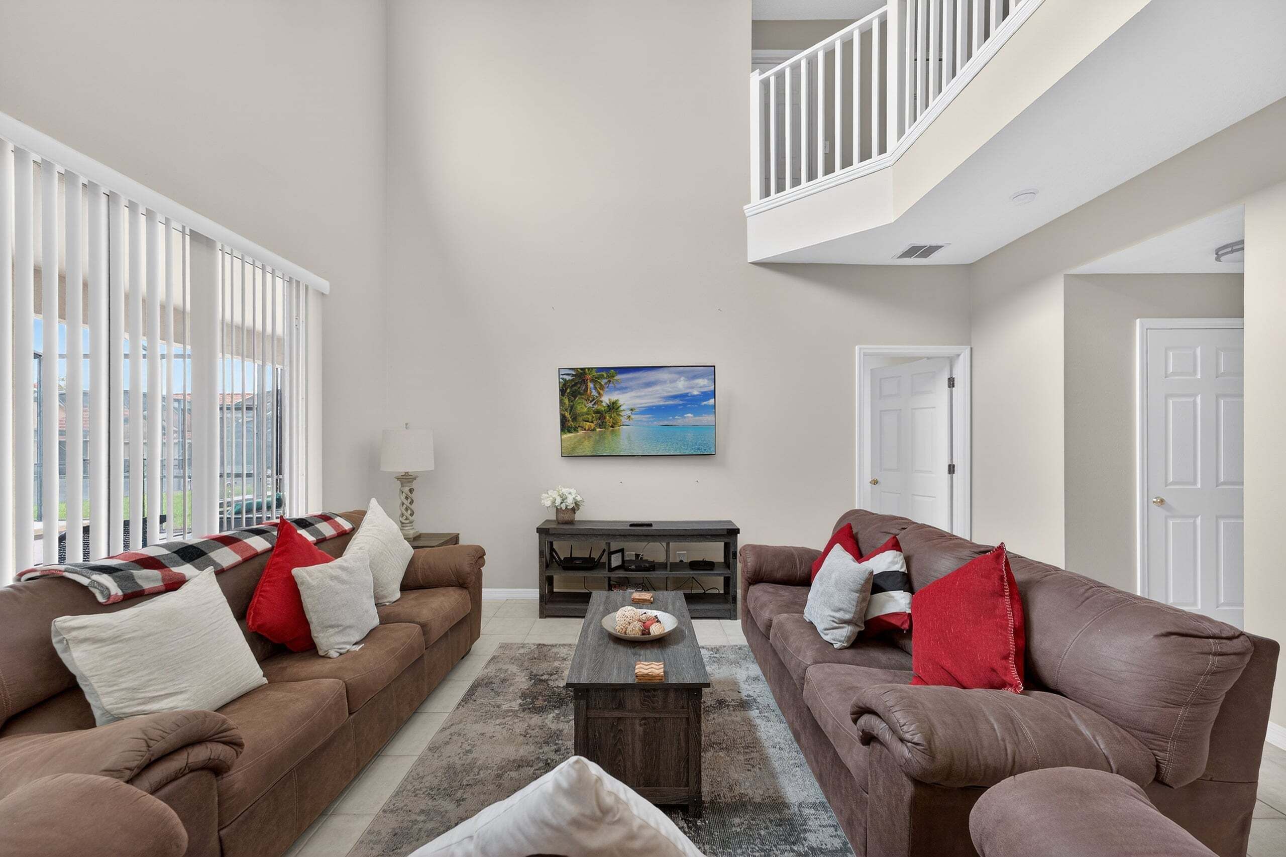 A living room with two sofas, a coffee table, and a painting on the wall.