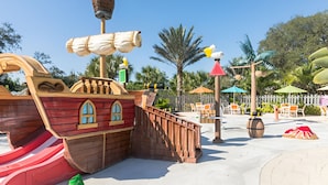 A pirate-themed play area with a ship structure, slides, and seating areas. - Lake View Villa Sleeps 8! (Davenport)
