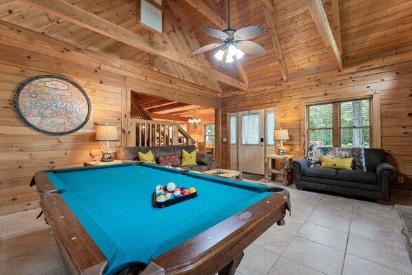 A wooden interior with a pool table, a sofa, and a chandelier. - Authentic Log Cabin Mins to Thunder Ridge&Big Cedar_Free Attraction Tickets_Pvt Hot Tub_Pool Table (Hollister)