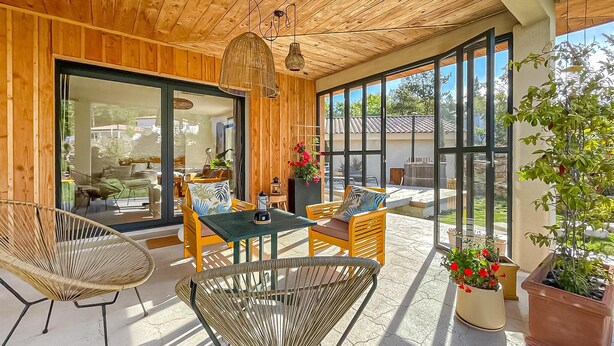 A wooden interior with a glass door leading outside, a table with chairs, and potted plants. - 3 bedroom gorgeous home in Plan d'Aups-Sainte-Bau (Plan d'Aups-Sainte-Bau)