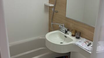 Combined shower/bathtub, hair dryer, slippers, towels