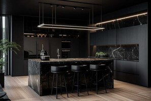 A modern kitchen with a marble island, black bar stools, and pendant lighting. - Charming 4-Bedroom Retreat in Carlton, VIC (Brisbane)