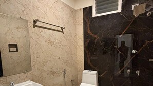 A bathroom with a sink, toilet, and shower. - Thamira Grand Palace (Nagercoil)